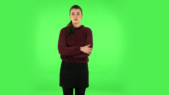 Female Listens Attentively and Nods His Head Pointing Finger at Viewer. Green Screen alt