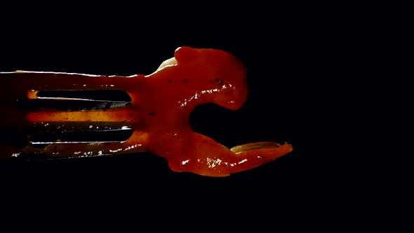 boiled juicy shrimp on a fork, poured with tomato sauce on a black background. vertical video alt