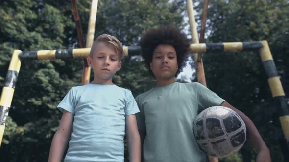 Upset Boys Looking Camera at Football Pitch, Lack of Friends, Bullying Problem