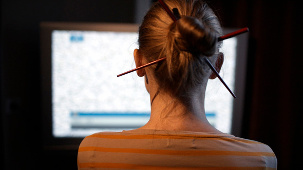 Woman Sitting In Front Of Tv Set alt