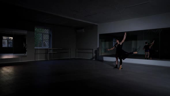 Extreme Wide Shot Dance Studio with Young Man Spinning Woman in Arabesque Position on the Right alt