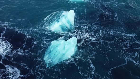 Iceberg in the Ocean Huge Chunks of Blue Ice Floating on the Waves Arctic Landscape Aerial View alt