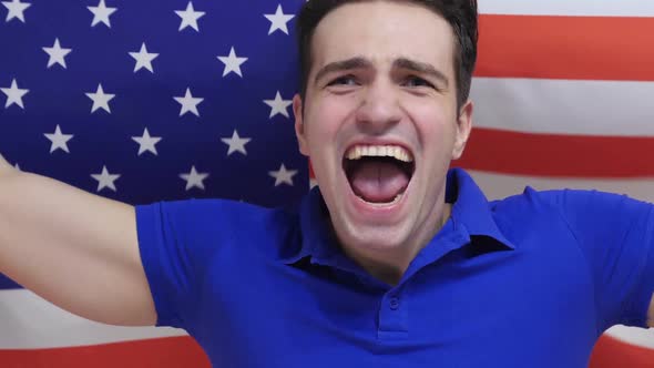 American Young Man Celebrates Holding the Flag of USA in Slow Motion alt