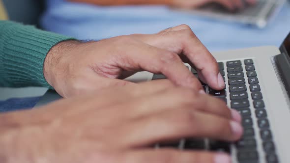 Mid section of man using a laptop alt