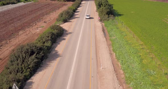 Beautiful day at rural side of the Country, Highway with car passing by blue sky in the Background