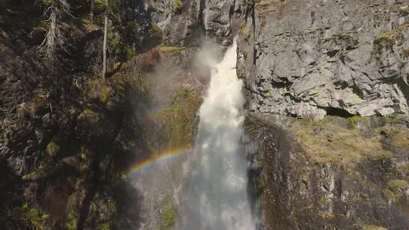 Waterfall Rushing Down a Rocky Canyon in the Canadian Mountains alt