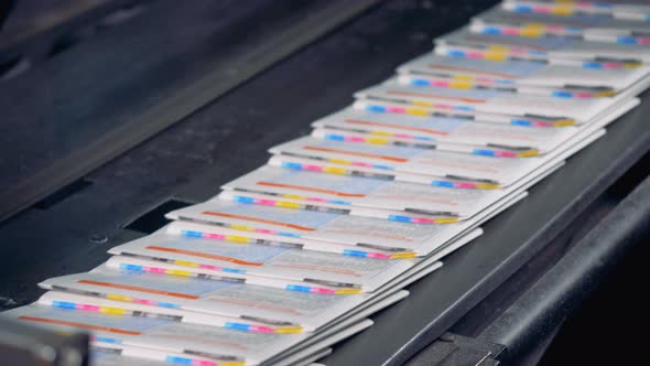 Many Newspaper Sheets on a Conveyor, Close Up. Printing House Equipment. alt