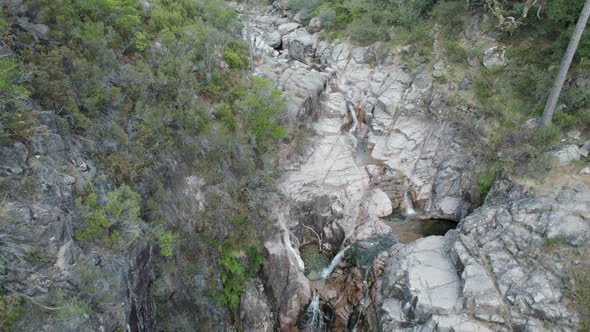 Aerial flyback over pristine water of waterfall of Portela Do Homem in Portugal