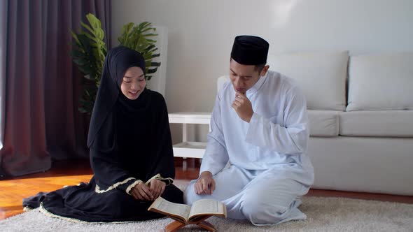 Handsome Muslim man teaching young woman read Quran  alt