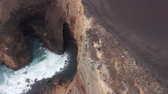 Overall View of the Rocky Cliff with the Ocean in the Background alt