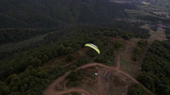 Following After Paraglider Flying Above Ukrainian Carpathian Mountains alt
