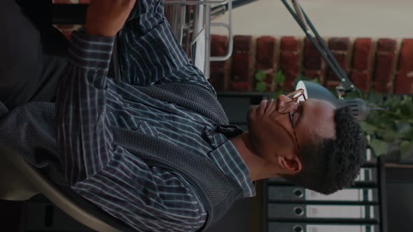 Vertical Video African American Employee Analyzing e Shopping Report alt