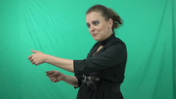Gorgeous Lady In Green Background Acting For A Charade Game - medium shot alt