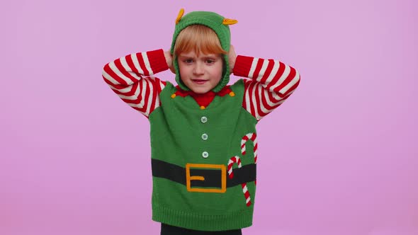 Girl Kid Christmas Elf Covering Ears and Gesturing No Avoiding Advice Ignoring Unpleasant Noise alt