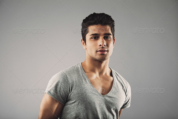 Portrait of handsome young man on grey background - Stock Photo - Images
