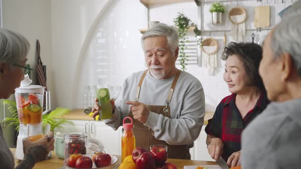 Group of Asian senior people friends making fruit juices for friends