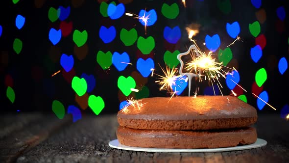 Minimalist Cake Placed on a Table with a Star Shaped Sparkler Getting Ignited in Celebration of New