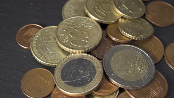 Closeup of European Union Currency Euro or EUR Coins on a Dark Slate Plate Background