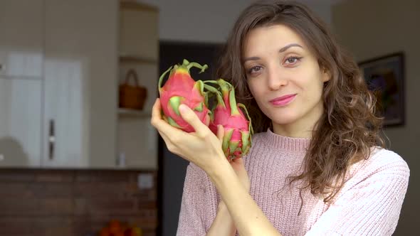Young Girl is Holding Two Fresh Ripe Organic Dragon Fruits or Pitaya Pitahaya alt