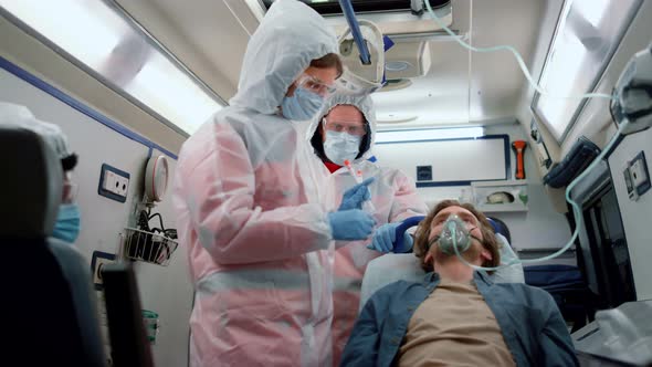 Mixed Race Doctors Taking Nasophargeal Swab of Patient for Coronavirus Sample alt