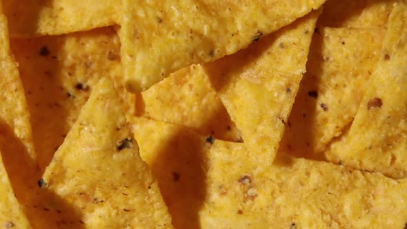 Rotation Macro Nacho Chips Background of Corn Tortilla Chips or Nachos alt