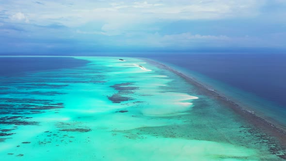 Luxury fly over island view of a sunshine white sandy paradise beach and blue water background in co alt