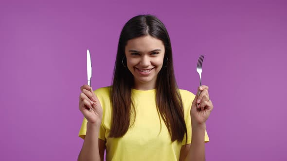 Portrait of Pretty Hungry Woman with Fork and Knife alt