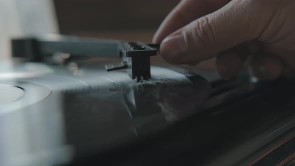 Close-up, Turntable Needle on a Vinyl Record, Male Hand Puts a Needle.
