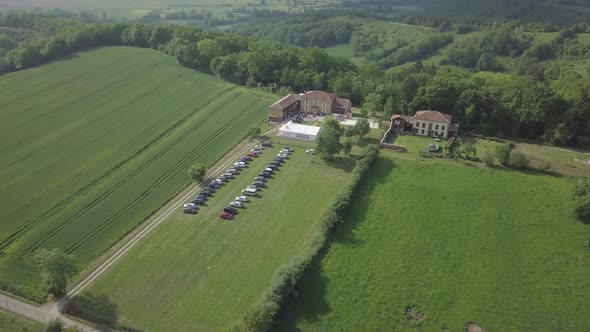 Aerial view of medieval french castle wedding party house on nature green field Sarremezan France