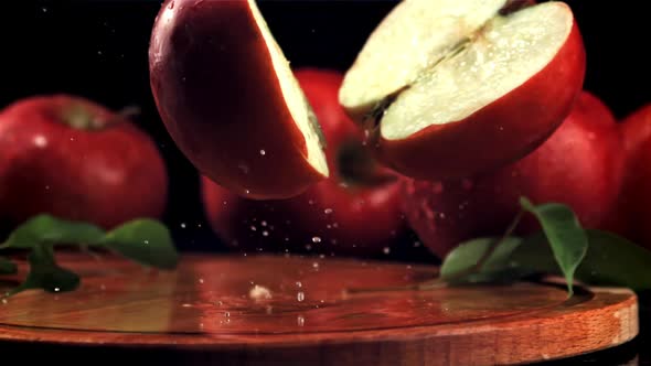 The Red Apple Falls on the Cutting Board and Splits Into Halves alt