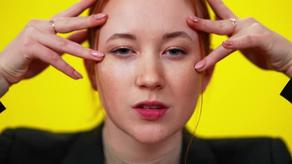 Headshot of Greeneyed Redhead Young Sensual Woman Touching Face Looking at Camera alt