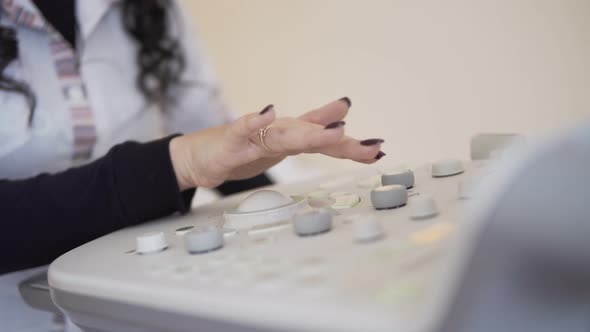 Ultrasound Device Keyboard Hands of Unrecognizable Doctor Working with Ultrasonic Equipment alt