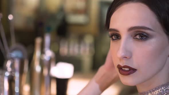 Closeup Portrait of a Young Attractive Woman in a 1920s Style at the Bar alt