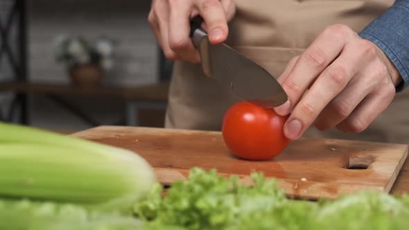 Cooking Salad at Home Man Hands Slicing a Tomato for a Salad alt