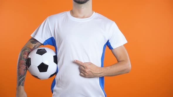 Close Shot Man Hand with Pointing Finger Follows Invisible Logo on Football Shirt alt