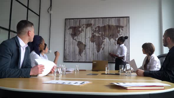 African American Female Business Coach Gives Corporate Presentation for Businesspeople in Office alt
