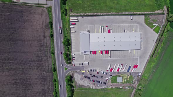 Aerial Top View of a of Semitrailer Truck Traveling Through the Parking alt