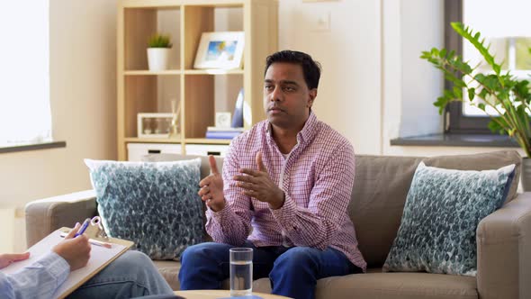 Man and Psychologist at Psychotherapy Session alt