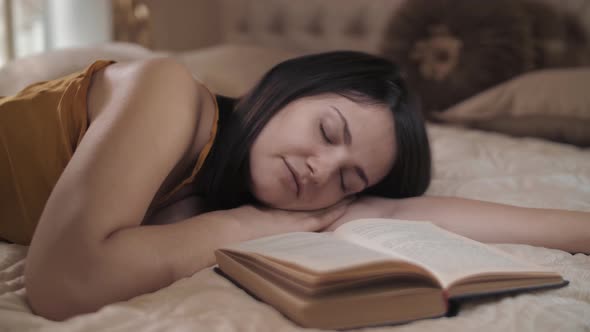 Beautiful Girl Fell Asleep Reading a Book