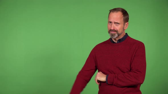 A Middleaged Caucasian Man Shows a Thumb Down to the Camera and Shakes His Head  Green Screen