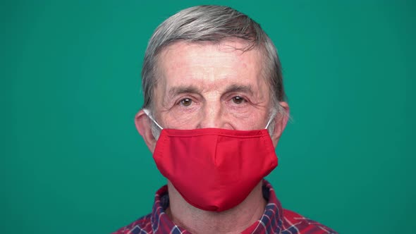 Portrait of Mature Man in Protective Red Medical Face Mask