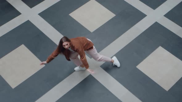 Woman Is Dancing On Tile With Geometric Pattern