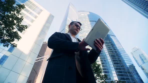 Male Successful Financial Expert Surrounded By Urban Buildings, Skyscrapers. alt