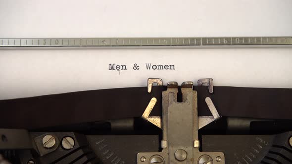 Typing phrase Men and Women on retro typewriter. Close up. alt