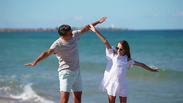 Little Girl and Happy Dad Having Fun During Beach Vacation