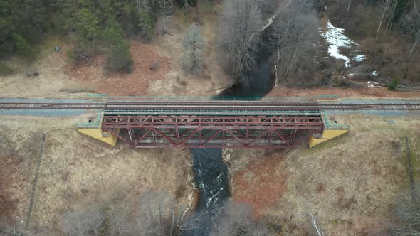 AERIAL: Old Metal Bridge Constructed Over Flowing River in Eastern Europe