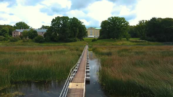 Aerial Shot City Mezotne, Latvia Republic. Mezotne Palace and Park With Fountain. Lielupe River With alt