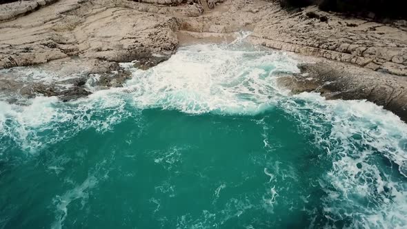 Aerial view of cliffs at Losinj coastline with agitated sea, Croatia. alt