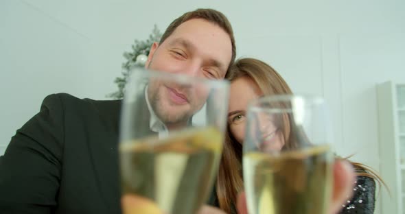 Close-up of Happy Young Couple Communicating By Video Call. Young Couple Waving at Camera and