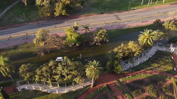 aerial view of the palermo lakes in buenos aires with a white boat followed by many ducks alt